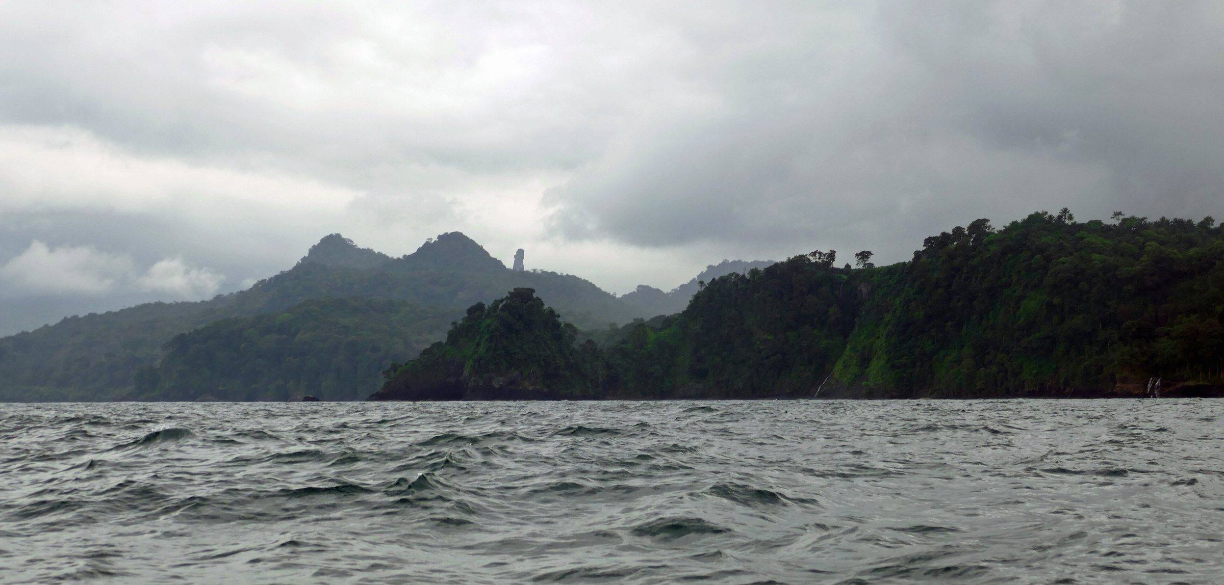 Rugged forested mountains of southern São Tomé seen from a rough sea