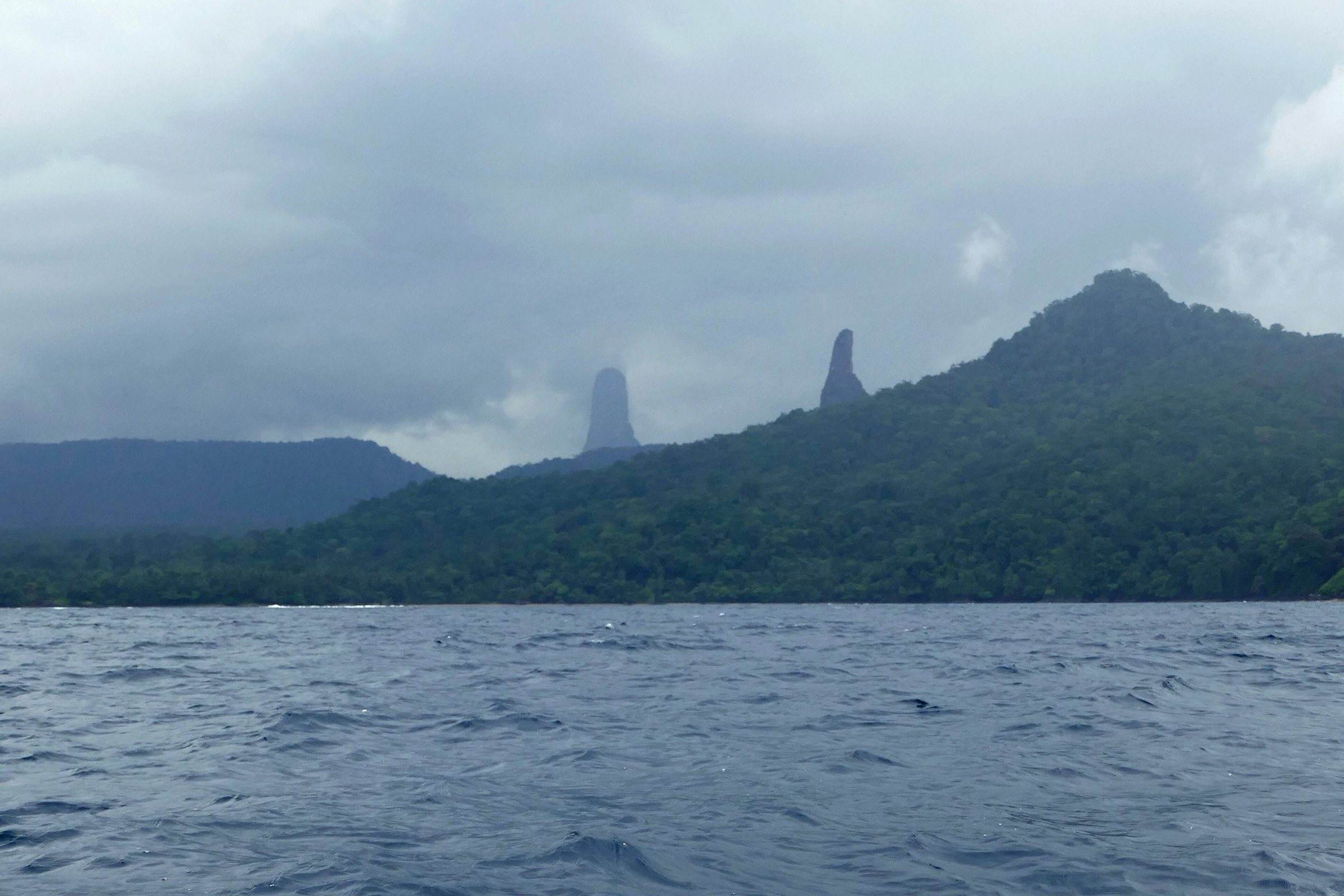 The twin volcanic spires of Cão Grande and Cão Pequeno seen from the sea off southern São Tomé