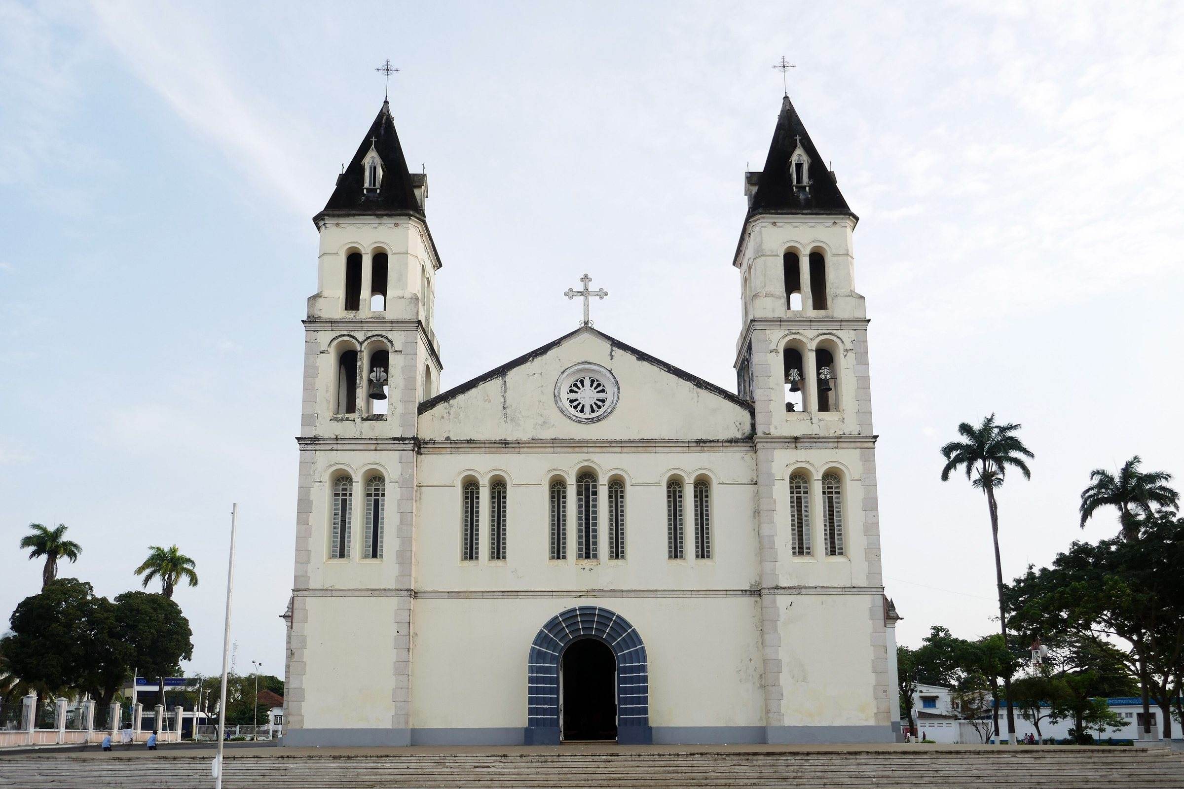 The white twin-towered facade of São Tomé cathedral under a blue sky
