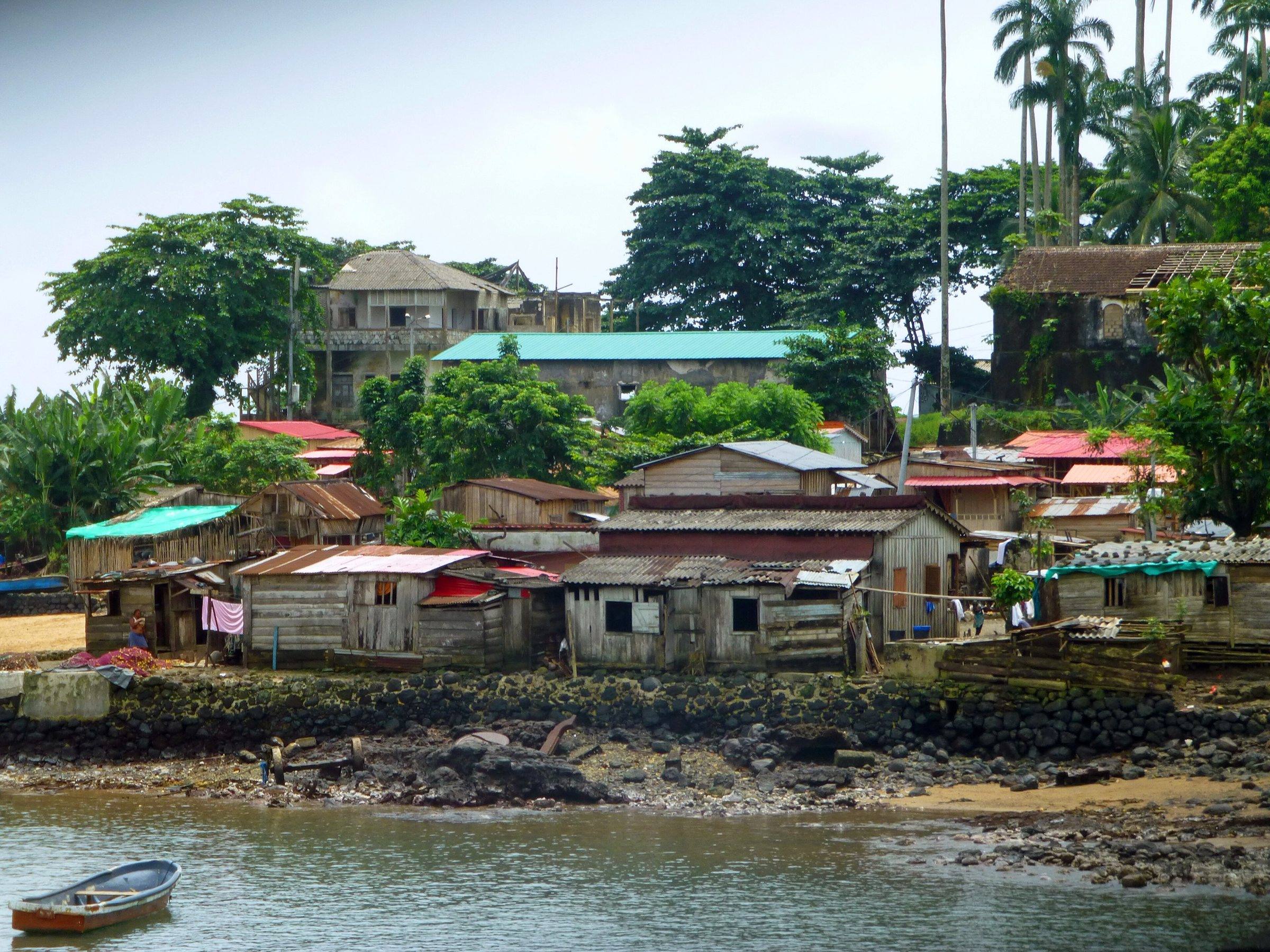Colourful stilt houses and a moored canoe at Porto Alegre