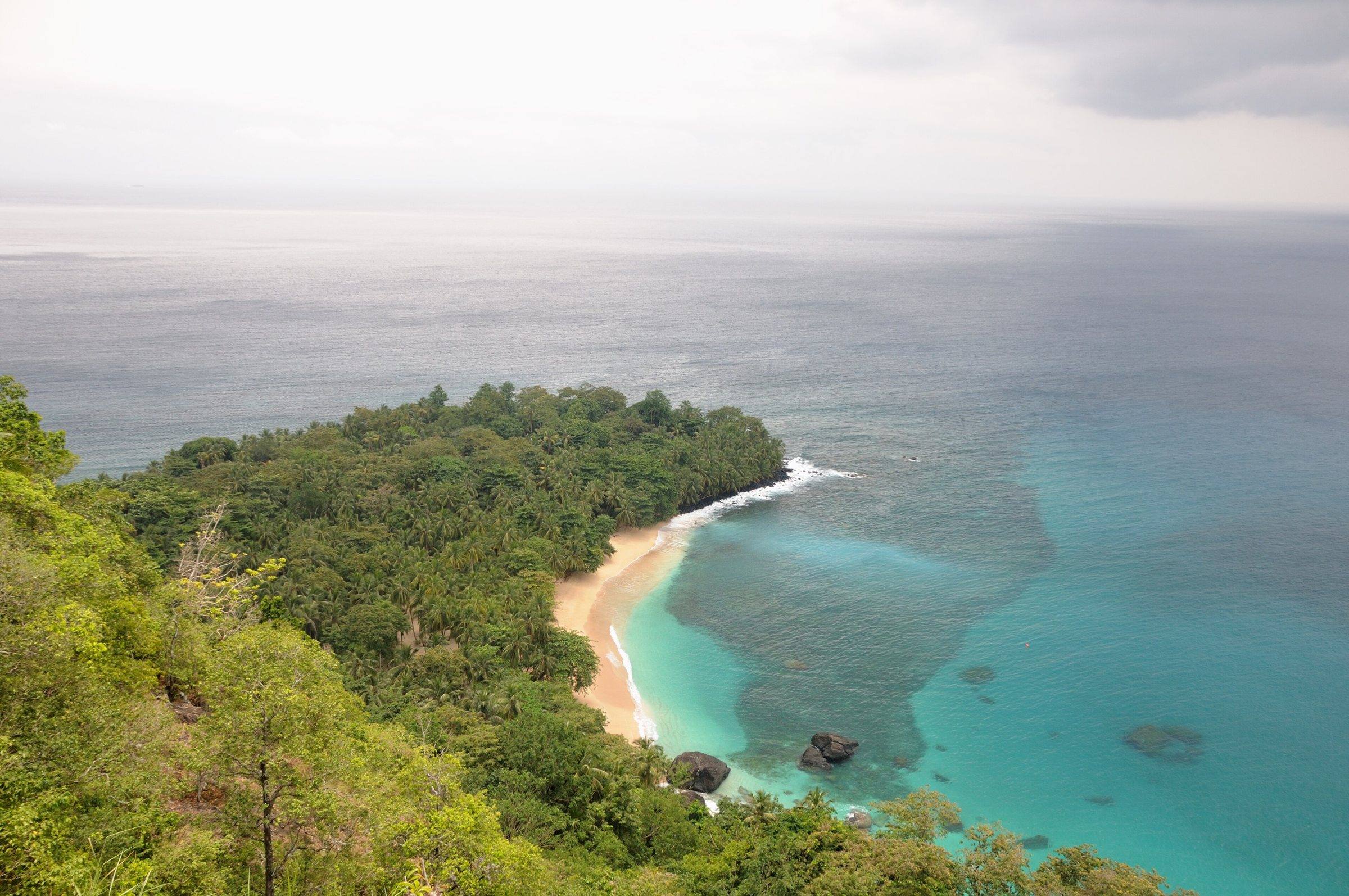 Praia Banana on Príncipe seen from the forested headland above, with turquoise water