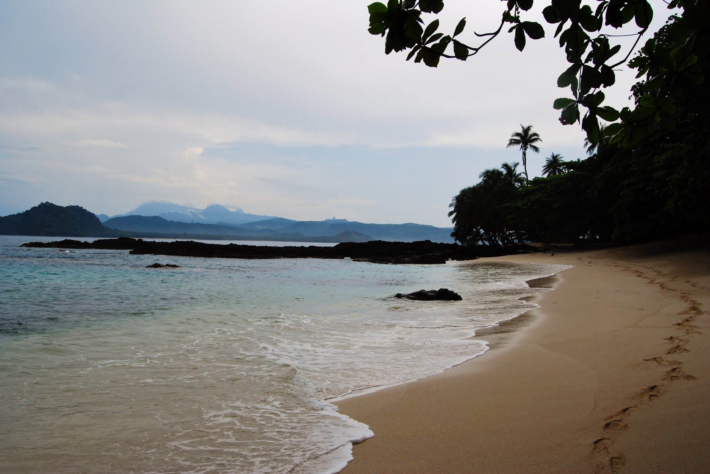 A sandy beach on Ilhéu das Rolas looking across to São Tomé