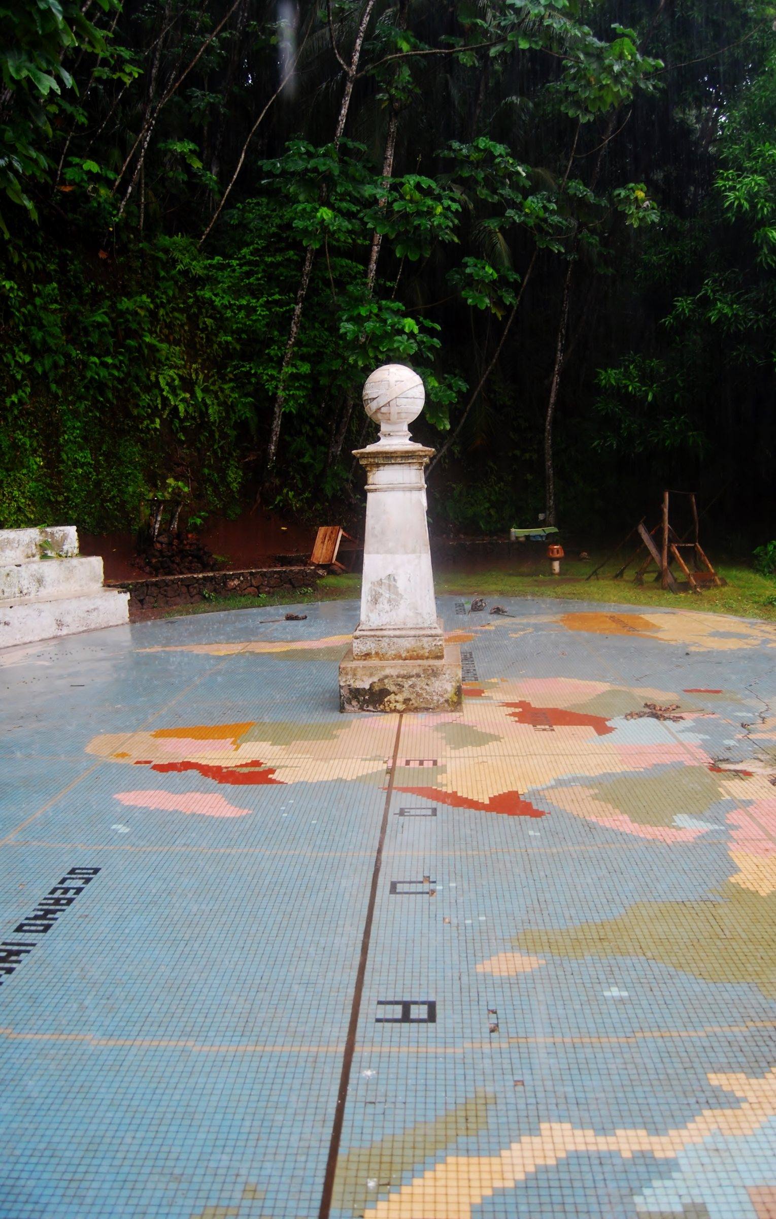 The equator monument on Ilhéu das Rolas with a tiled world map